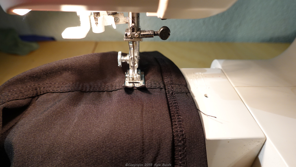 how to hem pants: step 5, option B. Fold extra fabric up and secure with a few stitches