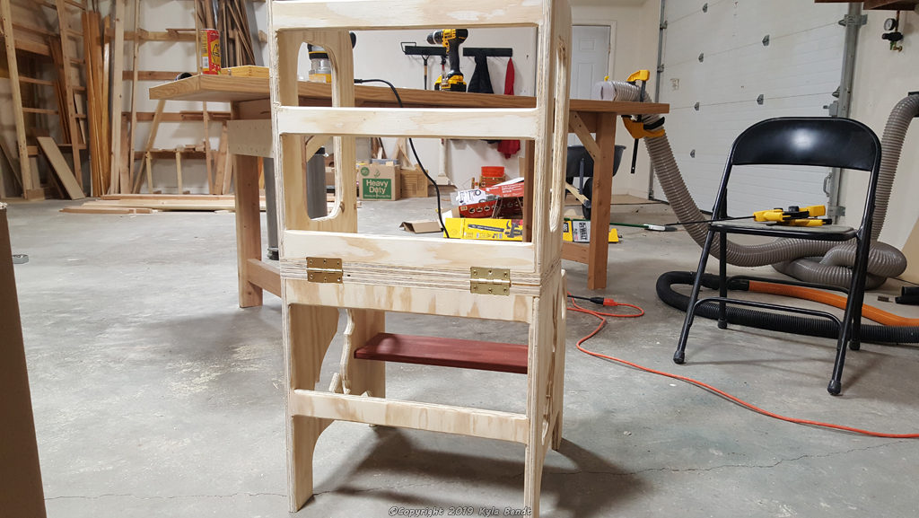 Unfinished convertible kid's step stool and table in step stool mode.